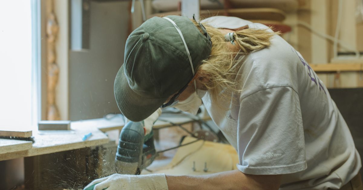 Craftsman working with hand tools in a woodworking workshop