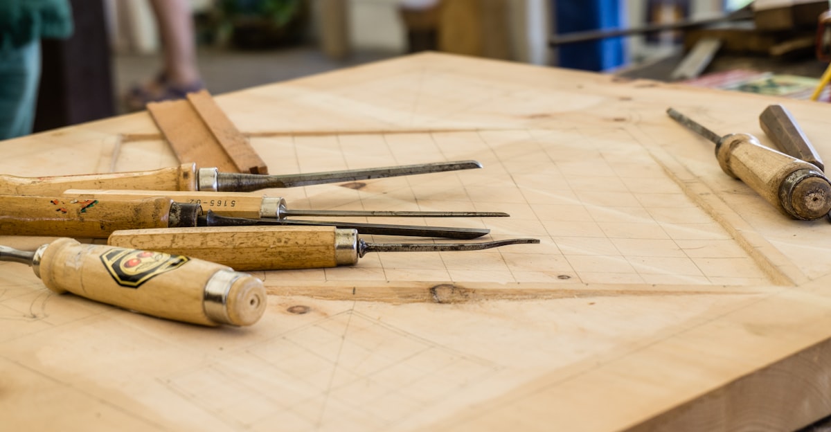 Wood carving knives and tools on a workshop bench